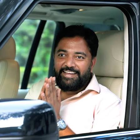 Rahul Awade greeting well-wishers with folded hands from a vehicle window in Ichalkaranji.