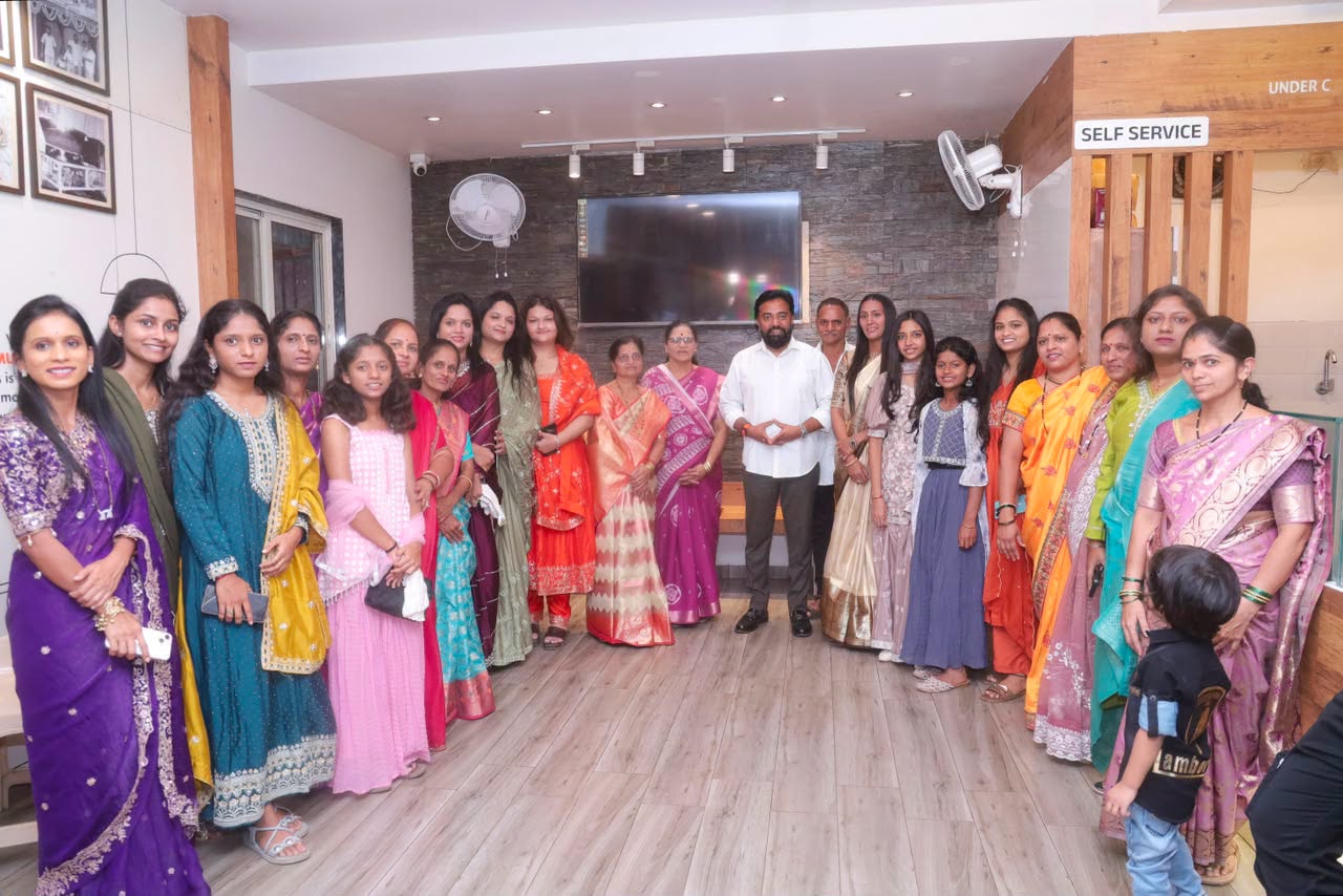 Rahul Awade standing with a large group of women and children at a community gathering in Ichalkaranji.