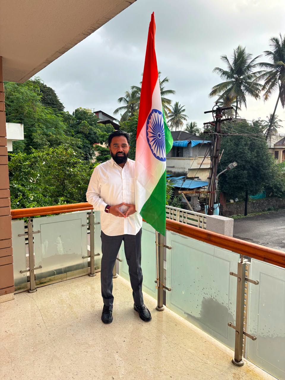 Rahul Awade, MLA for Ichalkaranji, holding the National Flag at his residence in Ichalkaranji.